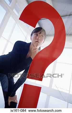 Woman behind large question mark View Large Photo Image Picture - Woman behind large question mark. Fotosearch