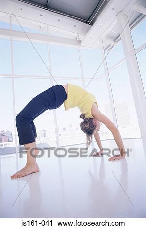Stock Image - Woman bending over backwards. Fotosearch
