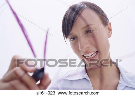 Stock Image - Woman drawing on glass. Fotosearch