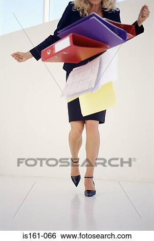 Stock Photograph - Woman dropping folders. Fotosearch