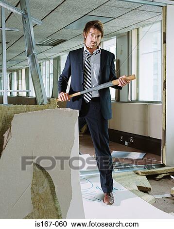 Stock Image - Businessman holding baseball bat. Fotosearch