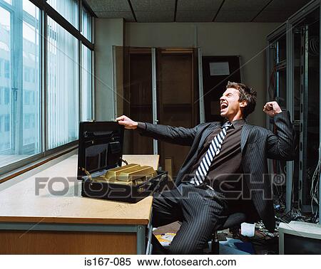 Stock Photography - Businessman with briefcase of gold bars. Fotosearch