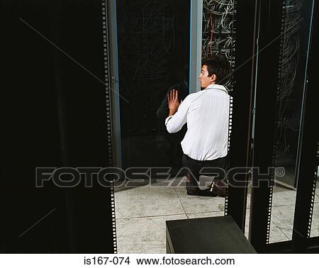 Man adjusting electrical cables View Large Photo Image Picture - Man adjusting electrical cables. Fotosearch