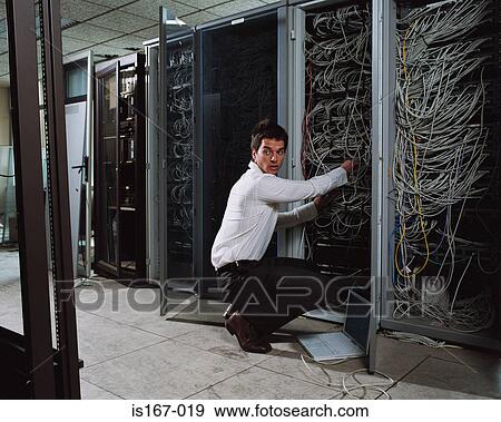 Man adjusting electrical cables View Large Photo Image Stock Photo - Man adjusting electrical cables. Fotosearch
