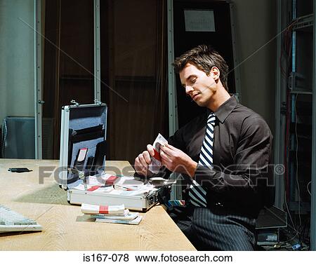 Man counting bundles of money View Large Photo Image Stock Photo - Man counting bundles of money. Fotosearch