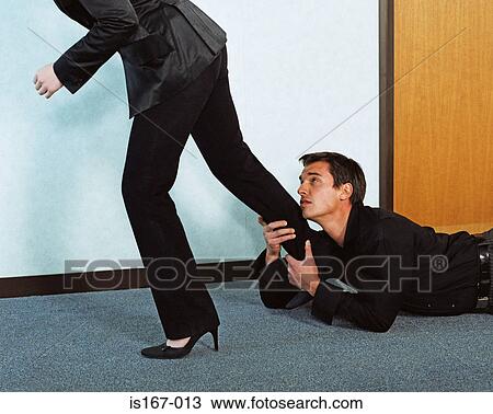 Stock Image - Man grabbing woman's leg. Fotosearch