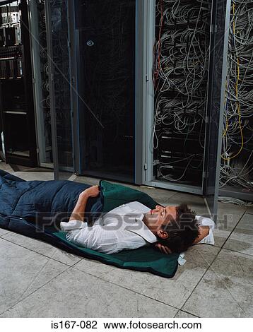 Stock Image - Man sleeping in office. Fotosearch