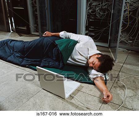 Man sleeping next to laptop View Large Photo Image Stock Photograph - Man sleeping next to laptop. Fotosearch