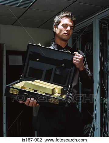 Stock Image - Man with a briefcase of gold bars. Fotosearch