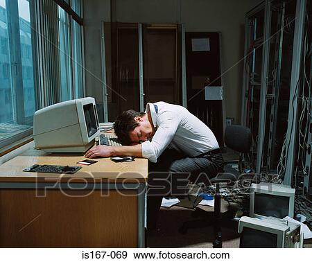 Office worker slumped on his desk View Large Photo Image Stock Photo - Office worker slumped on his desk. Fotosearch