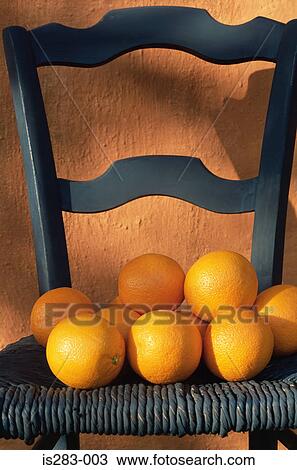 Stock Image - Oranges on a blue chair. Fotosearch