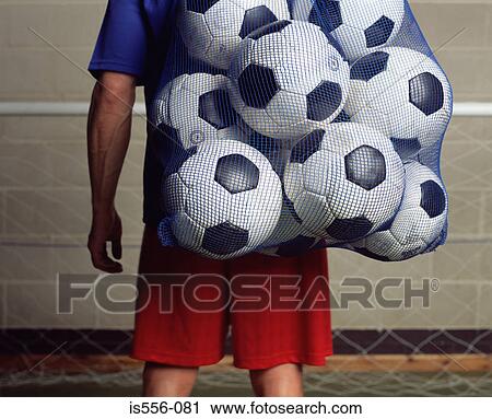Footballer holding a bag of footballs View Large Photo Image Stock Image - Footballer holding a bag of footballs. Fotosearch