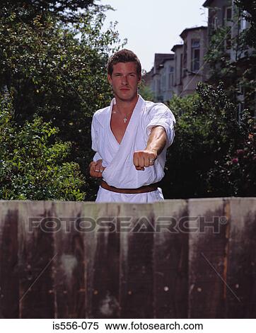 Stock Photography - Man doing karate in garden. Fotosearch