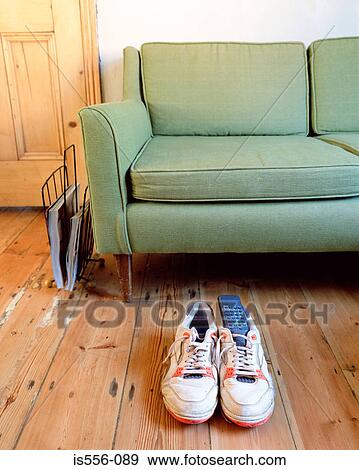 Trainers and remote control in apartment View Large Photo Image Stock Photo - Trainers and remote control in apartment. Fotosearch