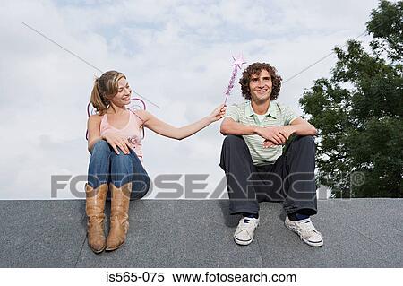Angel casting a spell on a man View Large Photo Image Stock Photography - Angel casting a spell on a man. Fotosearch