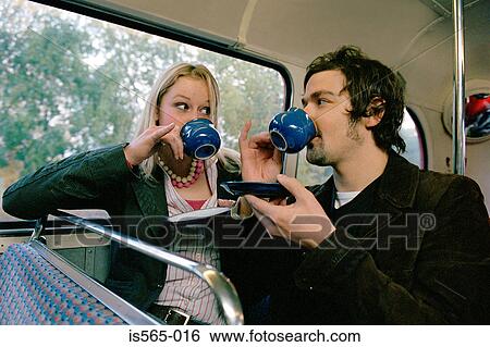 Stock Photograph - Couple drinking tea on bus. Fotosearch