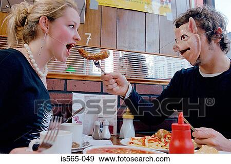 Stock Photo - Couple eating in cafe. Fotosearch