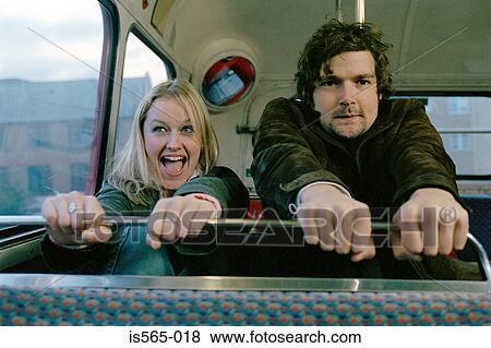 Couple grasping bus seat View Large Photo Image Stock Photo - Couple grasping bus seat. Fotosearch