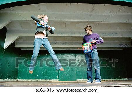 Stock Photography - Couple playing air guitar on stage. Fotosearch