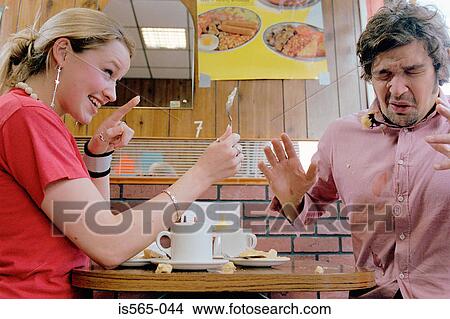 Couple playing in cafe View Large Photo Image Picture - Couple playing in cafe. Fotosearch
