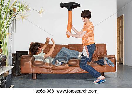 Couple playing with inflatable hammer View Large Photo Image Stock Photo - Couple playing with inflatable hammer. Fotosearch