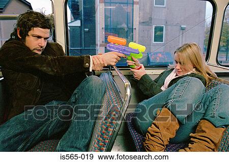 Stock Photo - Couple with water pistols. Fotosearch