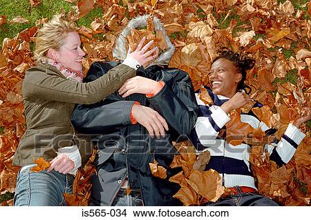 People playing in leaves View Large Photo Image Picture - People playing in leaves. Fotosearch