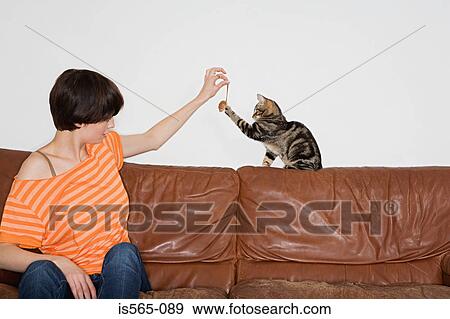 Woman playing with her cat View Large Photo Image Stock Photo - Woman playing with her cat. Fotosearch