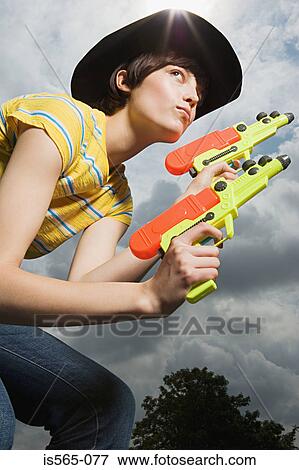 Woman playing with toy guns View Large Photo Image Stock Photo - Woman playing with toy guns. Fotosearch