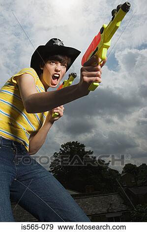Woman playing with toy guns View Large Photo Image Stock Photo - Woman playing with toy guns. Fotosearch