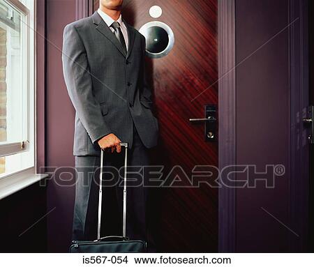 Businessman outside hotel room View Large Photo Image Picture - Businessman outside hotel room. Fotosearch