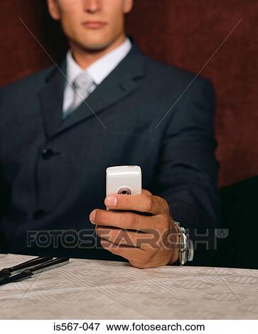 Businessman reading a text message View Large Photo Image Stock Photo - Businessman reading a text message. Fotosearch