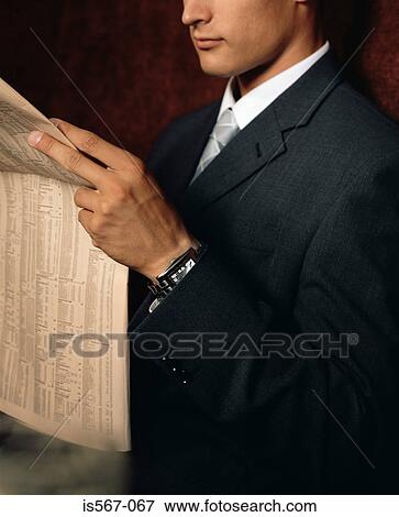 Businessman reading financial newspaper View Large Photo Image Stock Photo - Businessman reading financial newspaper. Fotosearch