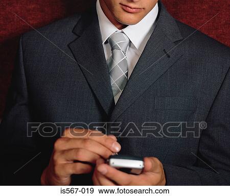Stock Photo - Businessman using handheld computer. Fotosearch