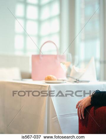Handbag on restaurant table View Large Photo Image Stock Photo - Handbag on restaurant table. Fotosearch
