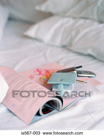Magazine on crumpled bed View Large Photo Image Stock Image - Magazine on crumpled bed. Fotosearch