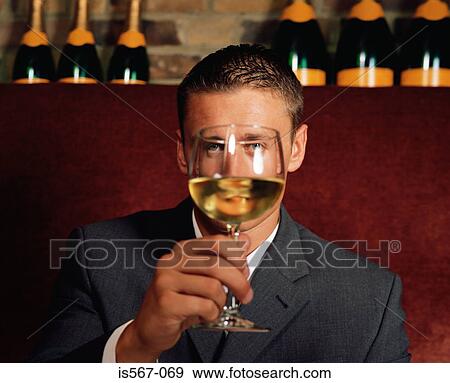 Man holding wine glass in front of his face View Large Photo Image Stock Photo - Man holding wine glass in front of his face. Fotosearch