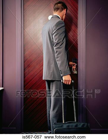 Man opening hotel room door View Large Photo Image Stock Photo - Man opening hotel room door. Fotosearch