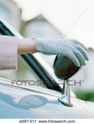 Woman adjusting rearview mirror View Large Photo Image Stock Photo - Woman adjusting rearview mirror. Fotosearch