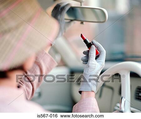 Woman applying lipstick in automobile View Large Photo Image Stock Photograph - Woman applying lipstick in automobile. Fotosearch