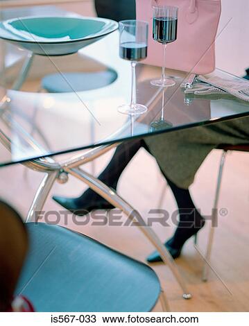 Woman sitting at glass table View Large Photo Image Stock Image - Woman sitting at glass table. Fotosearch