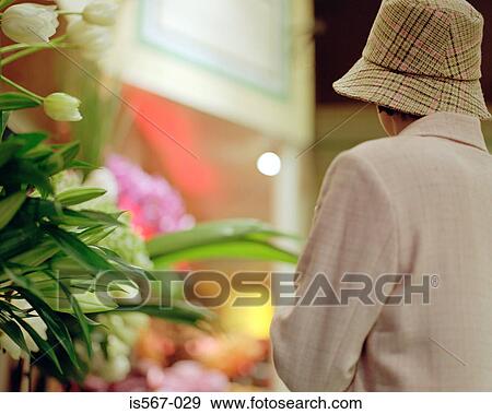Woman standing near florist View Large Photo Image Stock Photo - Woman standing near florist. Fotosearch
