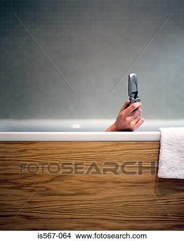 Woman text messaging in bath View Large Photo Image Picture - Woman text messaging in bath. Fotosearch