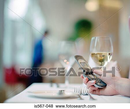 Woman text messaging in restaurant View Large Photo Image Stock Photo - Woman text messaging in restaurant. Fotosearch