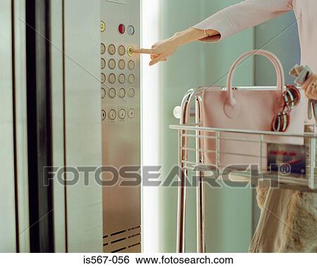 Stock Photograph - Woman waiting for an elevator. Fotosearch