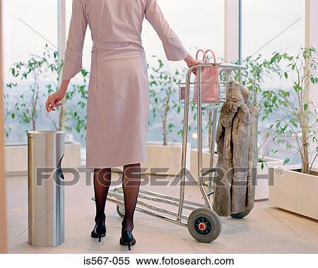 Woman with luggage trolley View Large Photo Image Stock Photography - Woman with luggage trolley. Fotosearch