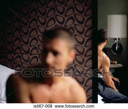 Stock Photo - Young man reflected in mirror. Fotosearch