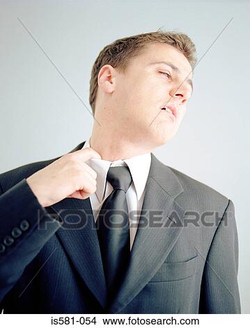 Businessman adjusting collar View Large Photo Image Picture - Businessman adjusting collar. Fotosearch