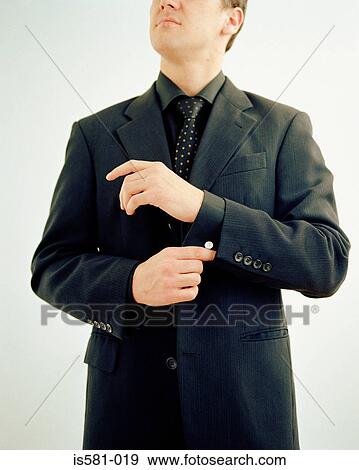 Stock Photo - Businessman adjusting sleeve. Fotosearch