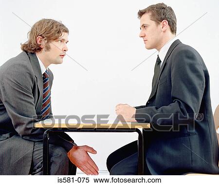 Stock Photography - Businessmen in meeting. Fotosearch